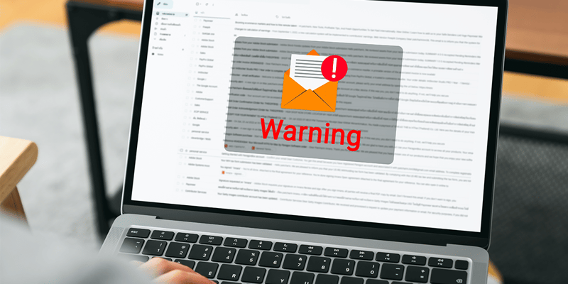 laptop showing a warning screen of new email notifications warning of phishing attempt.